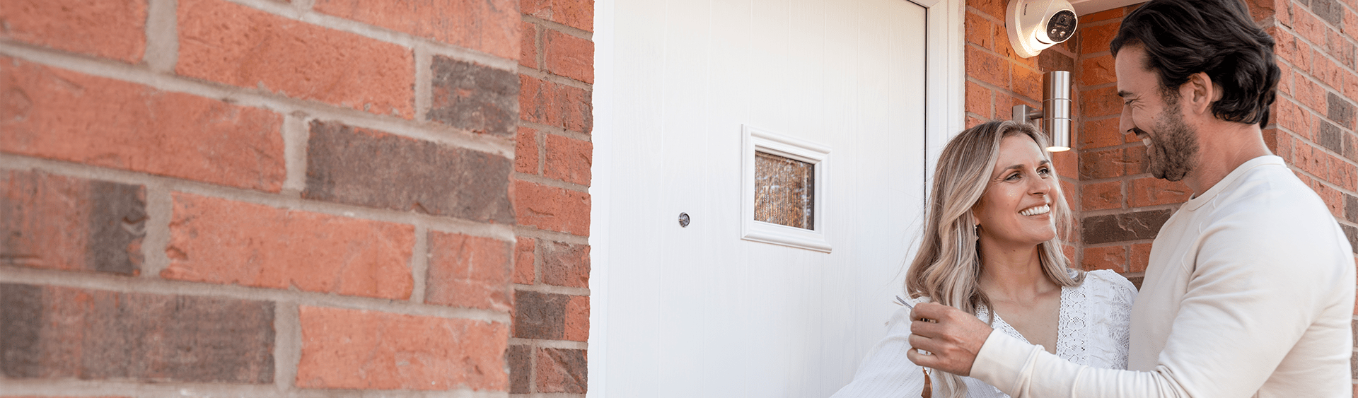A couple opening the door to their new Miller home